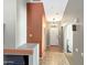 Bright hallway with neutral paint, tile flooring, and multiple doorways at 45726 W Long Way, Maricopa, AZ 85139