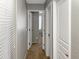 Neutral hallway featuring carpet, three doors and white trim at 45726 W Long Way, Maricopa, AZ 85139