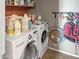 Functional laundry room with modern washer and dryer and practical storage shelves at 45726 W Long Way, Maricopa, AZ 85139