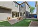 A private backyard featuring synthetic grass, a paved patio and low maintenance desert landscaping at 4712 E Bonanza Rd, Gilbert, AZ 85297