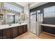 Modern bathroom featuring a double sink vanity, glass-enclosed shower, and a neutral color palette at 4712 E Bonanza Rd, Gilbert, AZ 85297