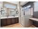 Modern bathroom featuring a double sink vanity, glass-enclosed shower, and a neutral color palette at 4712 E Bonanza Rd, Gilbert, AZ 85297