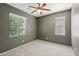 Neutral bedroom with carpet, two windows, and ceiling fan at 4712 E Bonanza Rd, Gilbert, AZ 85297