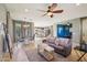 Open concept living room with ceiling fan, neutral colors, and ample natural light at 4712 E Bonanza Rd, Gilbert, AZ 85297