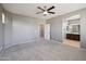 Spacious bedroom with en-suite bathroom access, ceiling fan, and ample lighting at 4712 E Bonanza Rd, Gilbert, AZ 85297