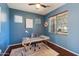 Bright home office with stylish desk, ceiling fan, and natural light at 4712 E Bonanza Rd, Gilbert, AZ 85297