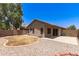 View of a backyard featuring gravel landscaping, a patio area, and a well-maintained exterior at 515 E Sherri Dr, Gilbert, AZ 85296