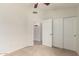Bedroom with carpeted floors, neutral walls, ceiling fan and closet at 515 E Sherri Dr, Gilbert, AZ 85296