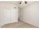 Bedroom featuring carpeted floors, neutral colored walls, closet and ceiling fan at 515 E Sherri Dr, Gilbert, AZ 85296