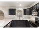Kitchen featuring dark cabinets, stainless steel appliances, and white countertops at 515 E Sherri Dr, Gilbert, AZ 85296