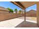 A covered patio in a backyard featuring rock landscaping and privacy walls at 515 E Sherri Dr, Gilbert, AZ 85296