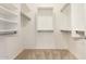 Walk-in closet featuring custom shelving and storage with carpeted flooring at 515 E Sherri Dr, Gilbert, AZ 85296