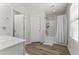 Well-lit bathroom with updated flooring, tub/shower combo, and white vanity sink at 5421 W Burton Dr, Phoenix, AZ 85043