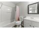 Bathroom with a tub and shower, and a vanity with a framed mirror at 5421 W Burton Dr, Phoenix, AZ 85043