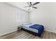 Simple bedroom with a bed, a window and a modern ceiling fan with lighting at 5421 W Burton Dr, Phoenix, AZ 85043