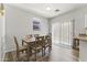 Bright dining area with a wooden table, six chairs, and sliding glass doors to the exterior at 5421 W Burton Dr, Phoenix, AZ 85043