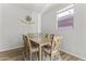 Bright dining room features a wooden table with six chairs and a window with natural light at 5421 W Burton Dr, Phoenix, AZ 85043
