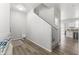 Hallway with hardwood floors, white walls, and a staircase leading to the upper level at 5421 W Burton Dr, Phoenix, AZ 85043