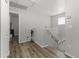 Upstairs hallway featuring wood-look floors, with stairs and railing on the right side of frame at 5421 W Burton Dr, Phoenix, AZ 85043