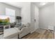 Cozy living room with gray walls, hardwood floors, comfortable seating, and a large TV at 5421 W Burton Dr, Phoenix, AZ 85043