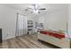 Well-lit main bedroom featuring wood-look floors, a bed and a ceiling fan with lighting at 5421 W Burton Dr, Phoenix, AZ 85043