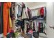 Organized walk-in closet features shelving with hanging racks for folded clothes, blouses, and dresses at 5421 W Burton Dr, Phoenix, AZ 85043