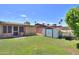 Green backyard with a storage shed, perfect for outdoor tools and a relaxing space at 5800 S College Ave, Tempe, AZ 85283