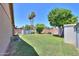 Well-maintained backyard featuring lush grass, mature trees, and a storage shed at 5800 S College Ave, Tempe, AZ 85283