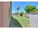 Lush backyard with green grass, mature trees, and a shed offering plenty of outdoor enjoyment at 5800 S College Ave, Tempe, AZ 85283