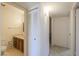 Hallway leading to a bathroom with a vanity and medicine cabinet at 5800 S College Ave, Tempe, AZ 85283