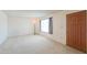 The empty living room features carpet floors and natural light from a window at 5800 S College Ave, Tempe, AZ 85283