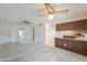 Spacious living room featuring ceiling fans and a convenient pass-through to the kitchen area at 5800 S College Ave, Tempe, AZ 85283
