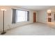 Bright living room with a neutral color palette and hardwood entry door at 5800 S College Ave, Tempe, AZ 85283