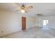 Open living room featuring sliding glass doors and two ceiling fans at 5800 S College Ave, Tempe, AZ 85283