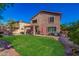 Backyard view of an expansive lawn with patio and a seating area at 7246 W Monte Cristo Ave, Peoria, AZ 85382