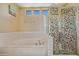 Beautiful bathroom featuring a soaking tub and a decorative glass shower at 7246 W Monte Cristo Ave, Peoria, AZ 85382