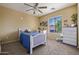 Comfortable bedroom with a twin bed, carpeted floors, and large window at 7246 W Monte Cristo Ave, Peoria, AZ 85382