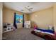 Cozy bedroom with a themed bed, window view, and a ceiling fan at 7246 W Monte Cristo Ave, Peoria, AZ 85382