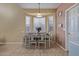 Charming dining room with a bay window, dining table set for six, and neutral décor at 7246 W Monte Cristo Ave, Peoria, AZ 85382