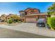 Beautiful two-story home with a three-car garage, tile roof, and well-manicured landscaping at 7246 W Monte Cristo Ave, Peoria, AZ 85382