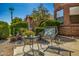 Cozy seating area in the front yard, featuring a table and chairs amidst lush greenery at 7246 W Monte Cristo Ave, Peoria, AZ 85382