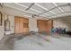 Spacious garage with ample storage cabinets and high ceilings, perfect for vehicles and hobbies at 7246 W Monte Cristo Ave, Peoria, AZ 85382