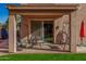 Covered patio with seating area, swing, and sliding door access to the home at 7246 W Monte Cristo Ave, Peoria, AZ 85382