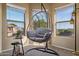 Bright sitting area with pendant chair and multiple windows at 7246 W Monte Cristo Ave, Peoria, AZ 85382