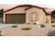 Charming single-story home featuring a desert landscape, a two-car garage, and a warm, inviting facade at 7891 S Summit Dr, Casa Grande, AZ 85193