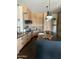 Modern kitchen featuring sleek black countertops, pendant lighting and wooden cabinets and backsplash at 9894 N 79Th Pl, Scottsdale, AZ 85258