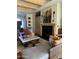 Comfortable living room featuring a fireplace, wooden beam ceiling, and modern decor at 9894 N 79Th Pl, Scottsdale, AZ 85258