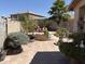 Charming backyard featuring mature trees, statues, unique decor, and a well-maintained patio at 9911 W Riverside Ave, Tolleson, AZ 85353