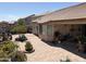 Spacious backyard showcasing a covered patio, pavers, lush landscaping, and mature trees at 9911 W Riverside Ave, Tolleson, AZ 85353