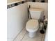 Powder room with white tile and all-white toilet at 9911 W Riverside Ave, Tolleson, AZ 85353